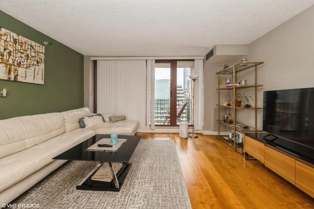 200 N Dearborn St Unit 3008, Chicago, IL 60601 - living area with a textured ceiling and light wood-type flooring