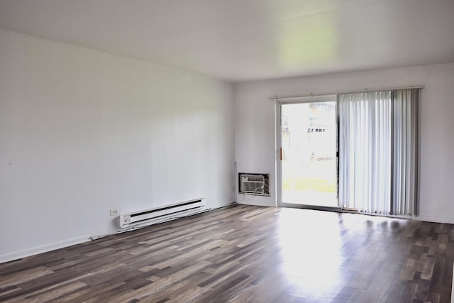 empty room with a baseboard radiator, an AC wall unit, and wood finished floors