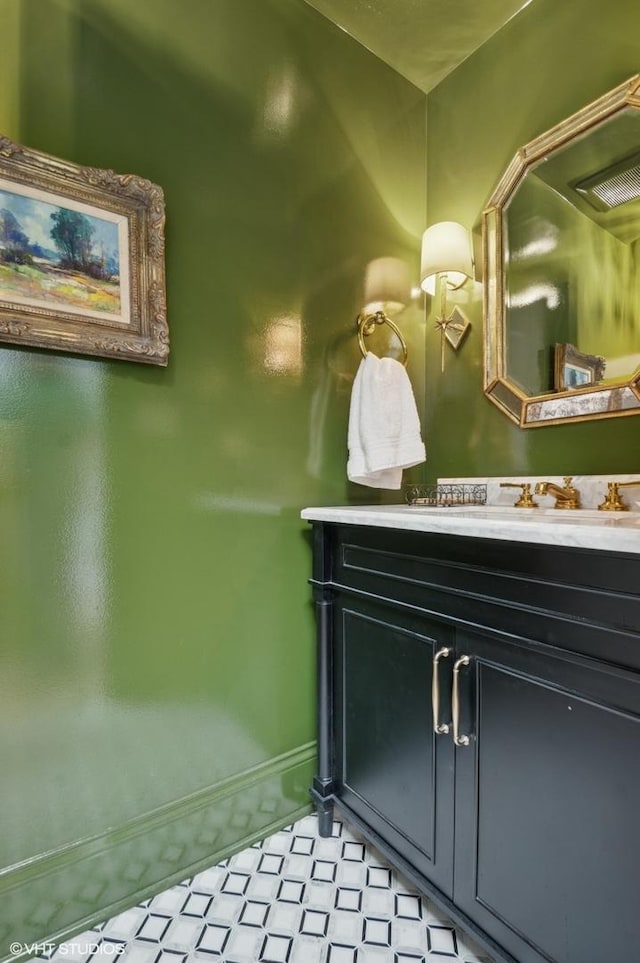 bathroom featuring vanity, baseboards, and tile patterned floors
