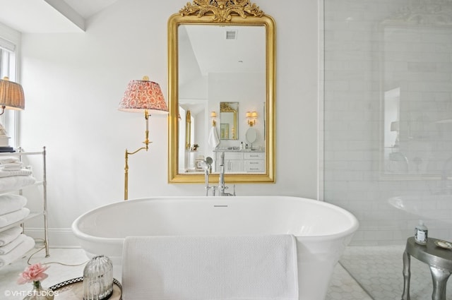 full bath featuring a freestanding bath and tile patterned floors