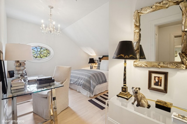 bedroom with wood finished floors, a chandelier, and lofted ceiling