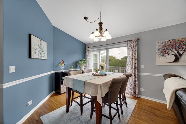 201 Charleston Ct Unit 2, Schaumburg, IL 60193 - dining room with a chandelier, wood finished floors, vaulted ceiling, and baseboards