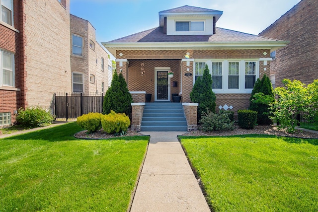 bungalow-style home featuring brick siding and roof with shingles