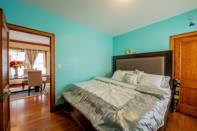 bedroom with wood finished floors and baseboards