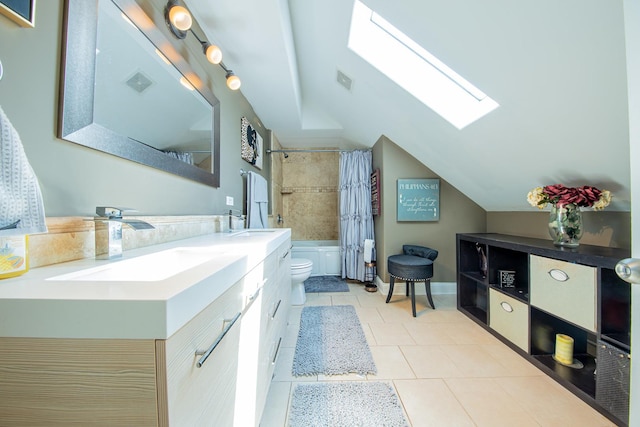 bathroom with a skylight, vaulted ceiling, toilet, shower / bath combo with shower curtain, and tile patterned floors