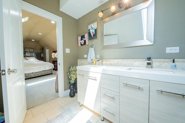 full bathroom featuring connected bathroom, vaulted ceiling, double vanity, tile patterned flooring, and recessed lighting