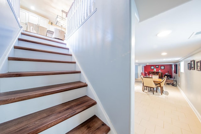 staircase featuring baseboards, recessed lighting, and tile patterned flooring