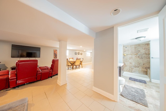 living room featuring light tile patterned flooring, baseboards, and recessed lighting