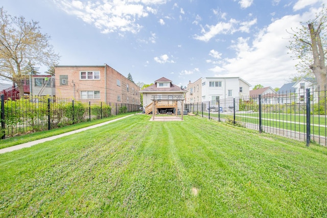 view of yard featuring a wooden deck and a residential view