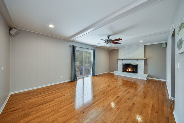 1528 Apache Dr, Naperville, IL 60563 - unfurnished living room with light wood-style floors, a ceiling fan, and a fireplace