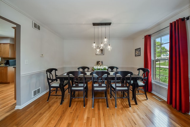 1528 Apache Dr, Naperville, IL 60563 - dining space featuring light wood-style flooring and ornamental molding
