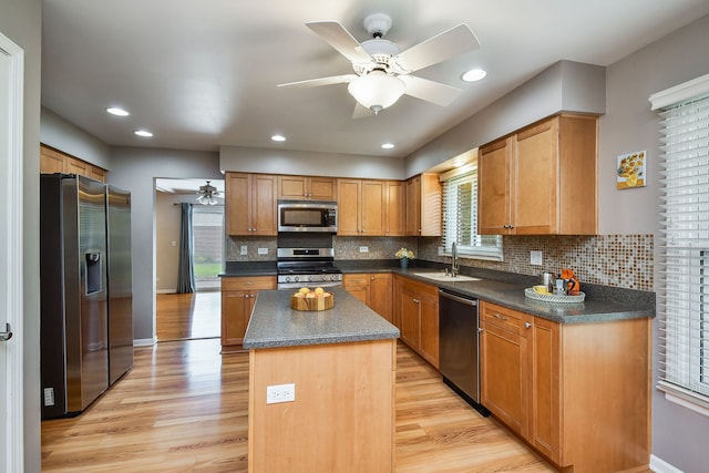 1528 Apache Dr, Naperville, IL 60563 - kitchen with stainless steel appliances, ceiling fan, dark countertops, a center island, and light wood-type flooring