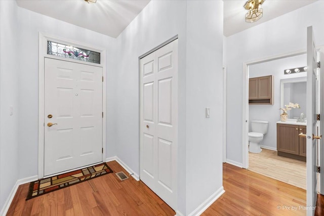 21148 W Cypress Ln, Plainfield, IL 60544 - entryway with light wood-type flooring and baseboards