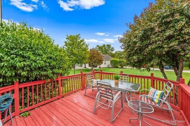 21148 W Cypress Ln, Plainfield, IL 60544 - wooden deck featuring outdoor dining space and a lawn