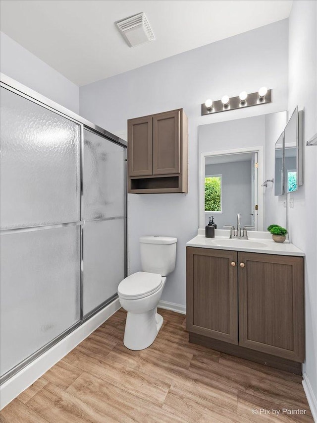 21148 W Cypress Ln, Plainfield, IL 60544 - full bath featuring vanity, toilet, a stall shower, wood finished floors, and baseboards