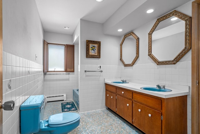 1N341 Indian Knoll Rd, West Chicago, IL 60185 - bathroom featuring tile walls, a baseboard heating unit, a wainscoted wall, double vanity, and a tub to relax in