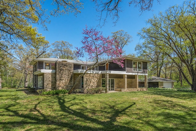 1N341 Indian Knoll Rd, West Chicago, IL 60185 - rear view of property with stone siding, a lawn, and a balcony