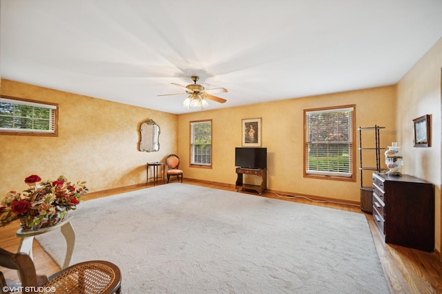 403 Minnaqua Dr, Prospect Heights, IL 60070 - unfurnished living room featuring healthy amount of natural light, a ceiling fan, wood finished floors, and baseboards