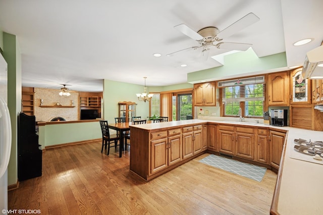 403 Minnaqua Dr, Prospect Heights, IL 60070 - kitchen with ceiling fan, a sink, a peninsula, a brick fireplace, and light countertops