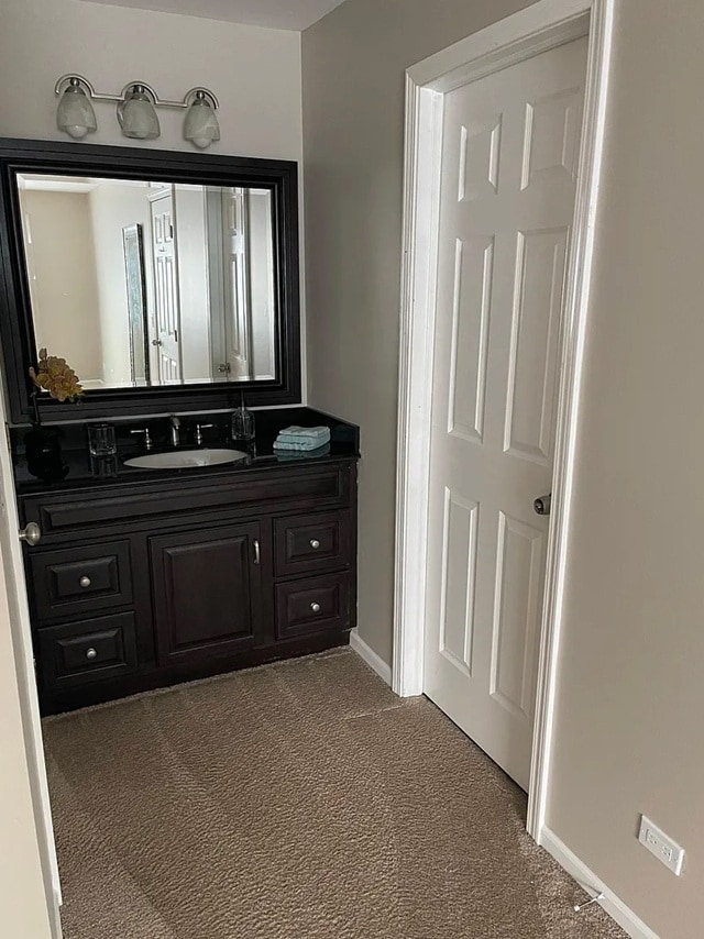 bathroom with vanity and baseboards