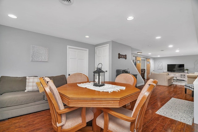 dining space featuring wood finished floors and recessed lighting