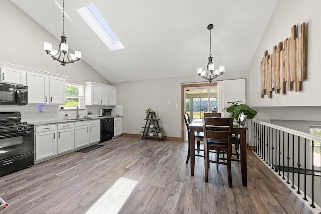 5306 Whisper Meadow Ct, Plainfield, IL 60586 - kitchen with black appliances, a chandelier, high vaulted ceiling, a sink, and tasteful backsplash