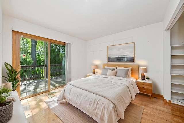 bedroom with access to outside and light wood-type flooring