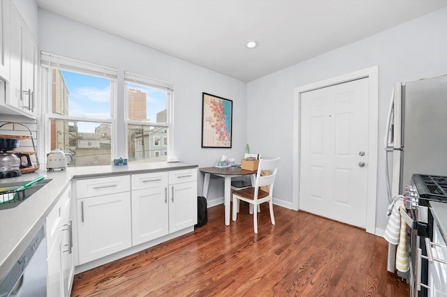 934 N Noble St, Chicago, IL 60642 - kitchen with stainless steel appliances, dark wood-style flooring, white cabinets, recessed lighting, and baseboards