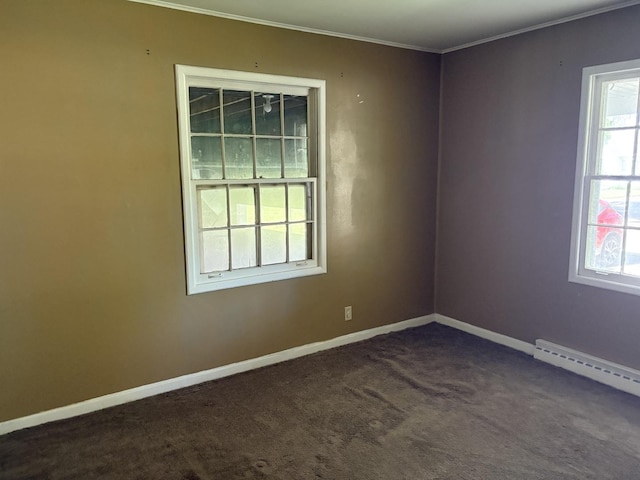 953 11th St N, Rochelle, IL 60168 - spare room with plenty of natural light, ornamental molding, dark colored carpet, baseboard heating, and baseboards