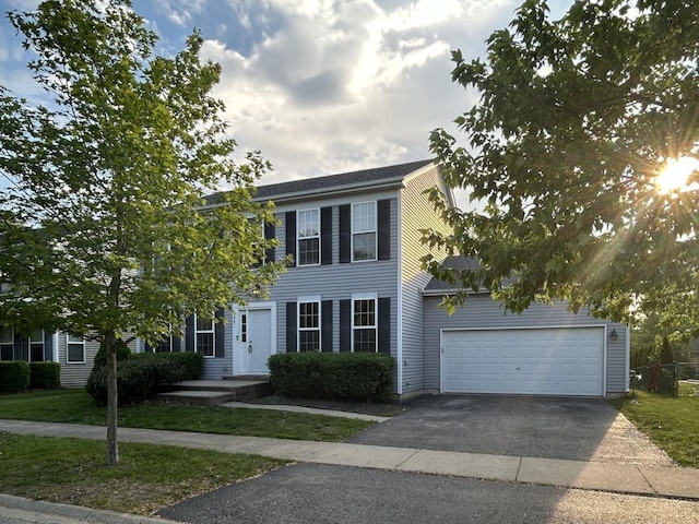 554 Truman Dr, Oswego, IL 60543 - colonial house with asphalt driveway and a garage