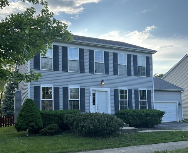 554 Truman Dr, Oswego, IL 60543 - colonial-style house with an attached garage, asphalt driveway, and a front yard