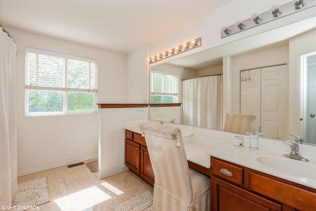 554 Truman Dr, Oswego, IL 60543 - full bathroom featuring plenty of natural light, vanity, tile patterned flooring, and baseboards