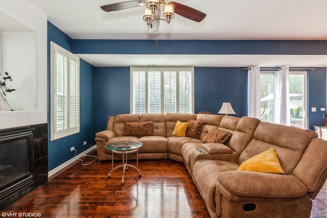 554 Truman Dr, Oswego, IL 60543 - living area featuring a ceiling fan, wood finished floors, a glass covered fireplace, and baseboards