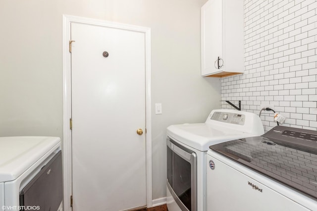 554 Truman Dr, Oswego, IL 60543 - laundry room featuring washer and clothes dryer and cabinet space
