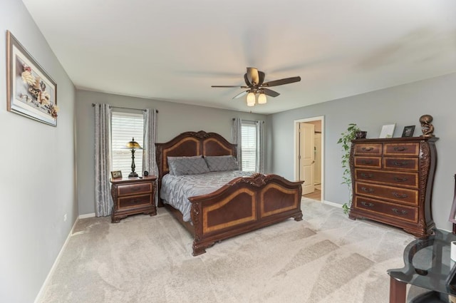 bedroom with baseboards, light colored carpet, and a ceiling fan
