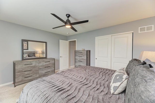 bedroom with light carpet, a closet, baseboards, and a ceiling fan