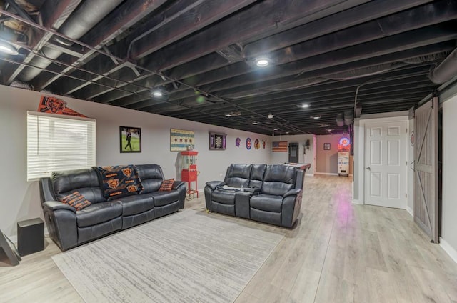 living room with wood finished floors and a barn door