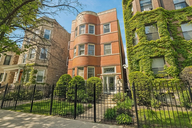 view of building exterior with a fenced front yard