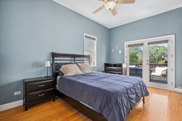 bedroom featuring access to outside, multiple windows, wood finished floors, french doors, and lofted ceiling