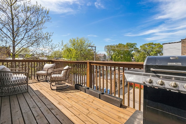 wooden terrace with a grill