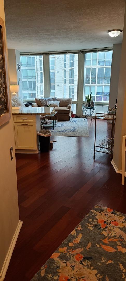 hallway with dark wood-type flooring and baseboards