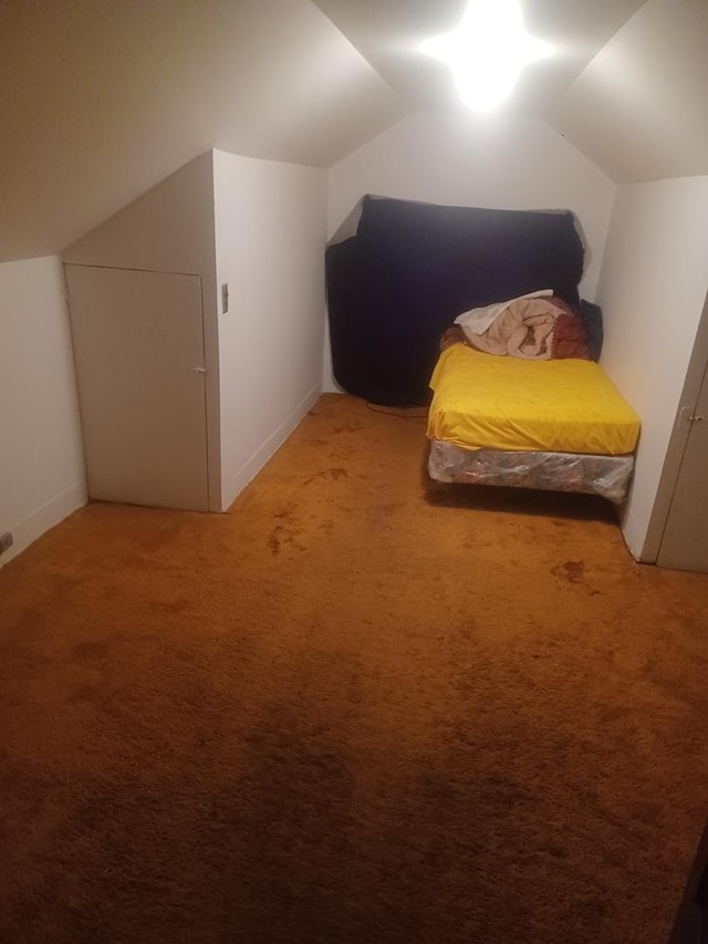 bedroom featuring lofted ceiling, light carpet, and baseboards