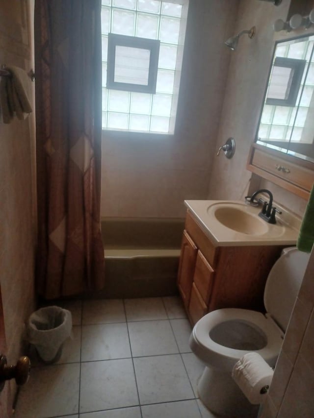 bathroom featuring toilet, tile patterned floors, shower / tub combo with curtain, and vanity