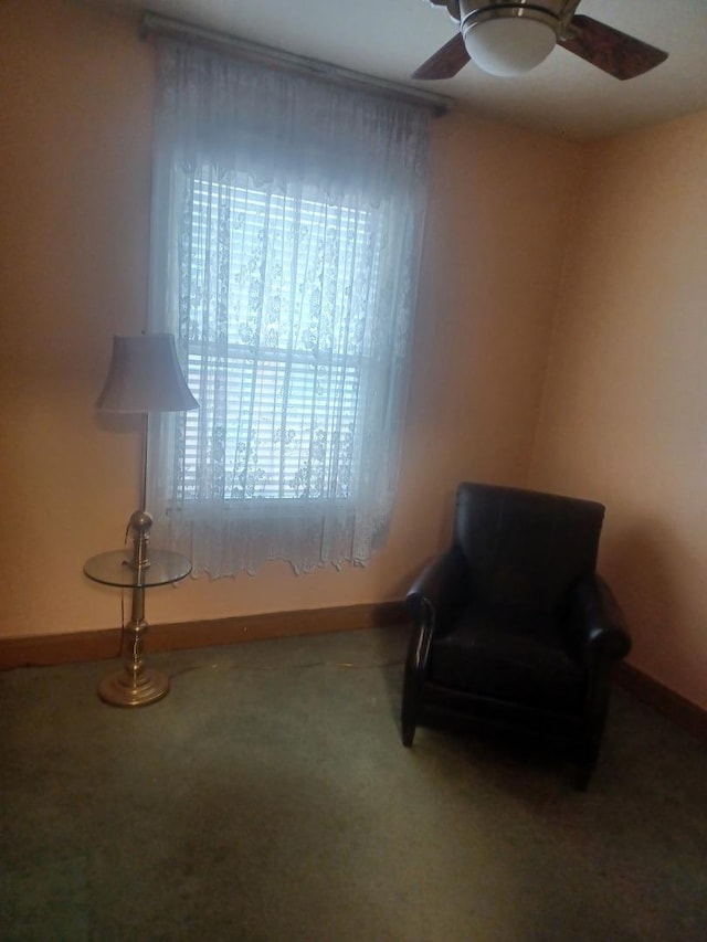 sitting room with carpet, baseboards, and ceiling fan