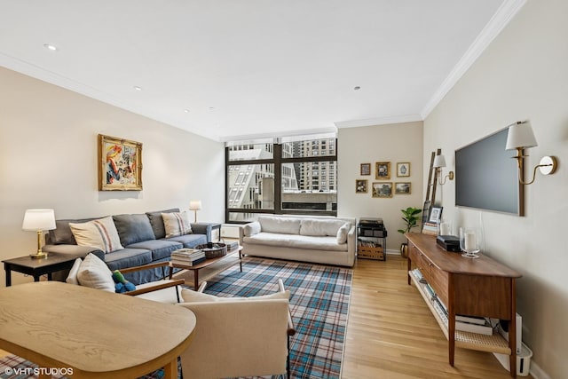 living room with light wood-type flooring, crown molding, baseboards, and recessed lighting