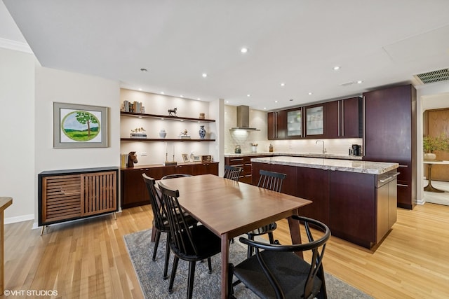 dining space featuring light wood-style flooring and recessed lighting