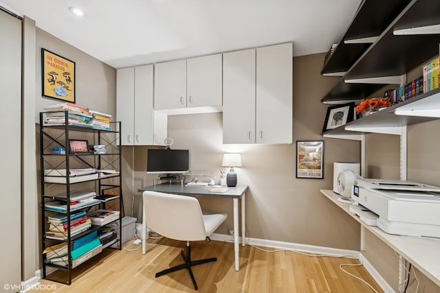 home office featuring light wood-style flooring and baseboards