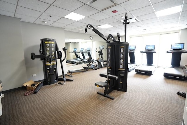 exercise room featuring a drop ceiling and carpet