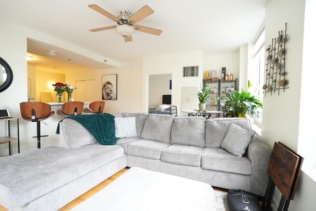 living area featuring ceiling fan and wood finished floors