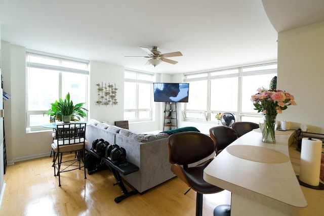 living area featuring ceiling fan and light wood-type flooring